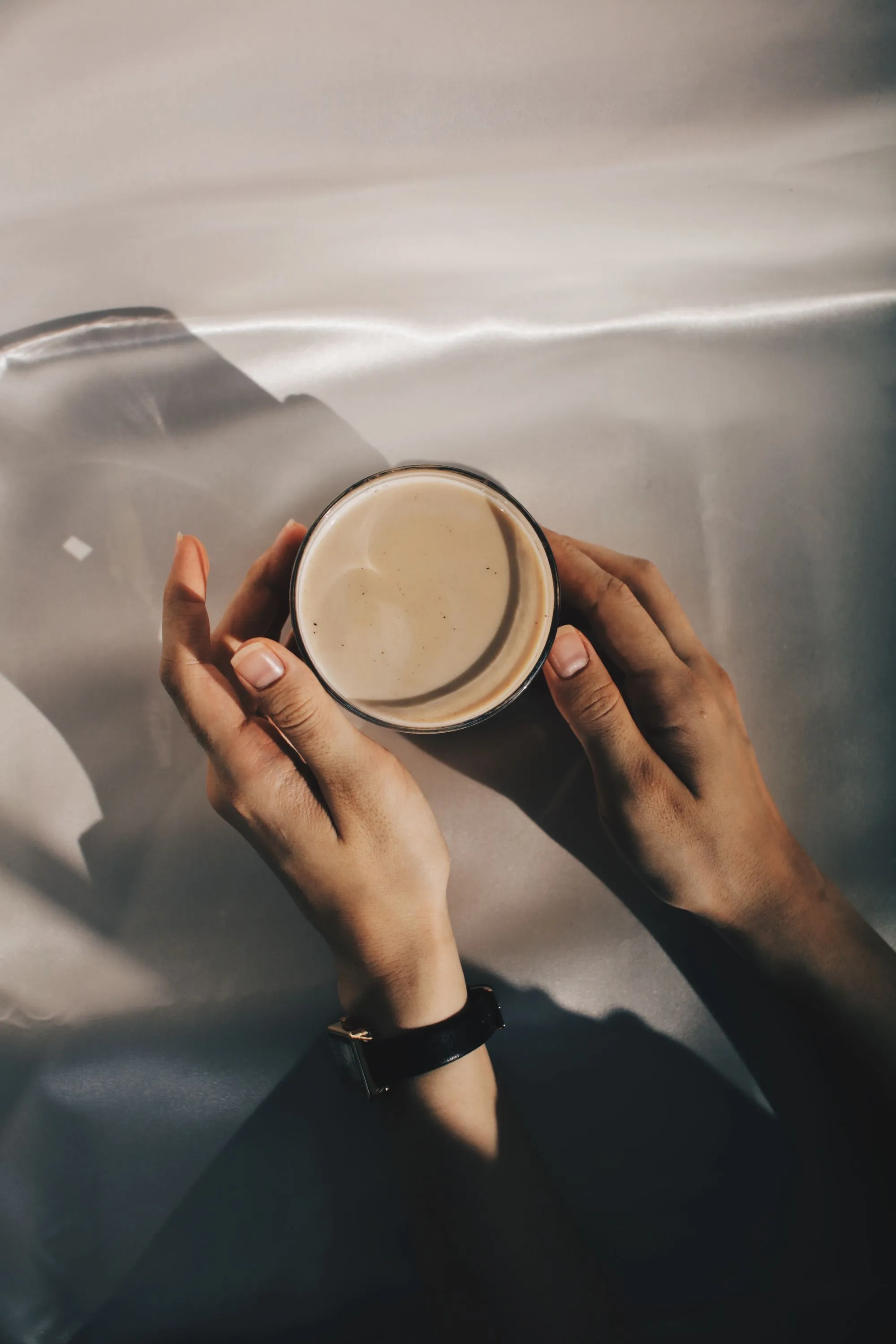 Hands cradling a warm mug of freshly brewed coffee